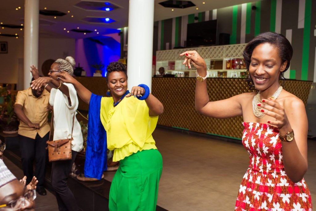 The crowd rose to their feet to perform Rwandan dance. Pictured L-R: Ugandan art curator and writer Moses Serubiri, Rwandan singer Iyadede, Professor Alice Karekezi of the University of Rwanda, and designer/poet Michaella Rugwizangoga